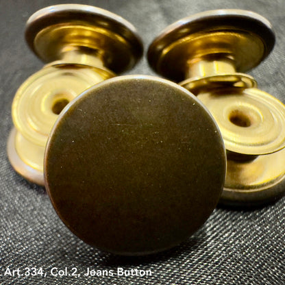 Metal jean button replacement set by Buttonology Inc with durable brass finish on black fabric