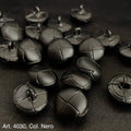Black leather shank buttons with stitched cross design from Buttonology Inc on black fabric