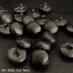 Black leather shank buttons with stitched cross design from Buttonology Inc on black fabric
