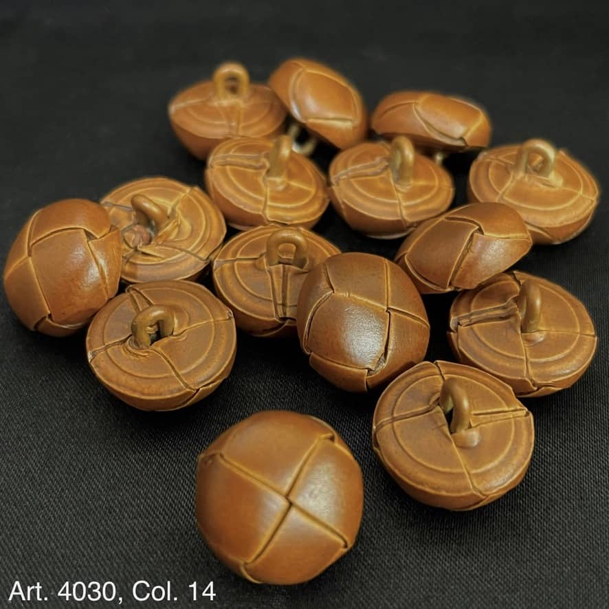 Buttonology Inc leather shank buttons in brown with stitched design on black background