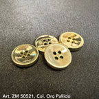 Shiny gold metal buttons for clothes with four holes laid on dark fabric background
