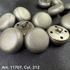 Metal dome buttons for coats with textured silver finish from Buttonology Inc close-up on dark fabric