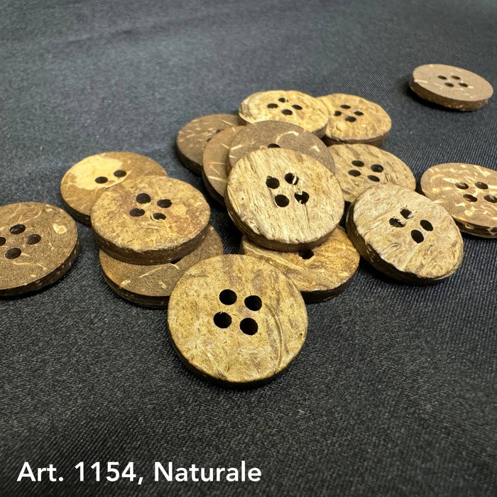 Natural textured coconut buttons for sewing with four holes on black fabric background