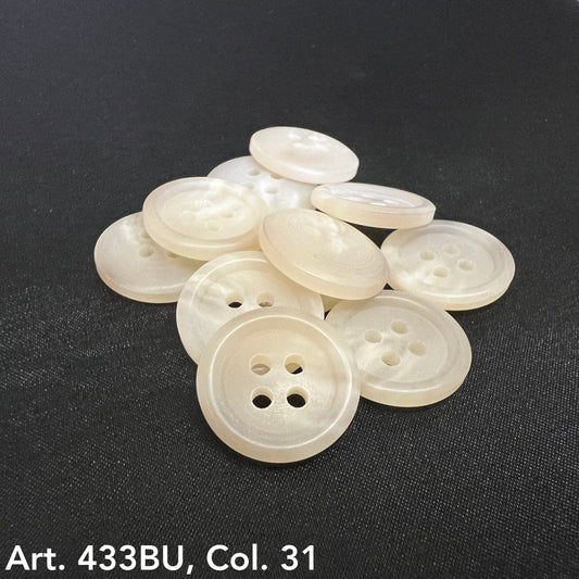 Set of pearlescent white buttons with four holes stacked on a black surface for online buttons for sale