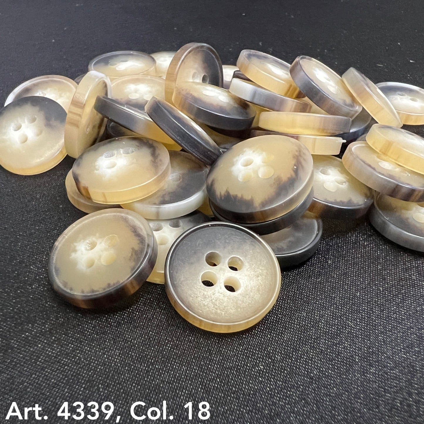 Plastic buttons sewing buttons in beige and brown tones with four holes from Buttonology Inc