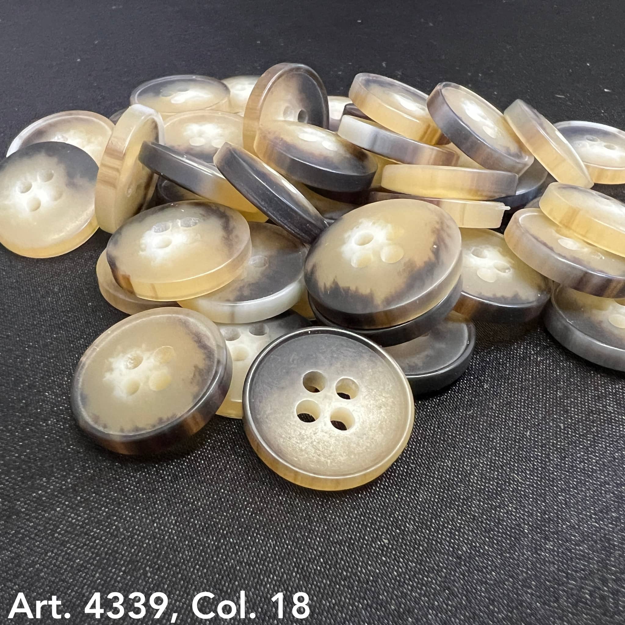 Plastic buttons sewing buttons in beige and brown tones with four holes from Buttonology Inc