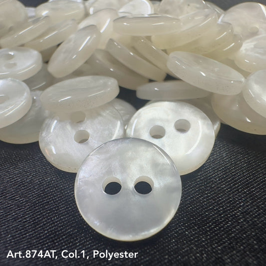 Close-up of shiny white polyester coat buttons from Buttonology Inc with two holes each