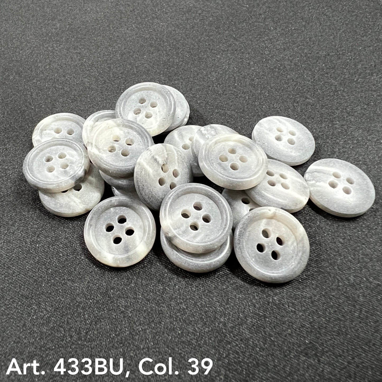 Premium 4-hole sewing buttons in a light gray color, perfect for garments and crafts