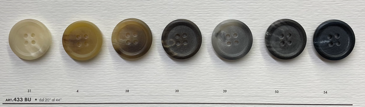 Variety of premium 4-hole sewing buttons in different colors from Buttonology Inc.