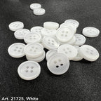 White buttons from the premium button collection by Buttonology Inc spread on dark fabric background