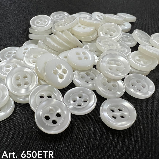 Premium garment buttons for clothes white round buttons with four holes on black fabric background