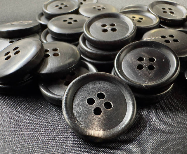 Premium horn sewing button by Buttonology Inc made of dark polished horn with four holes for sewing