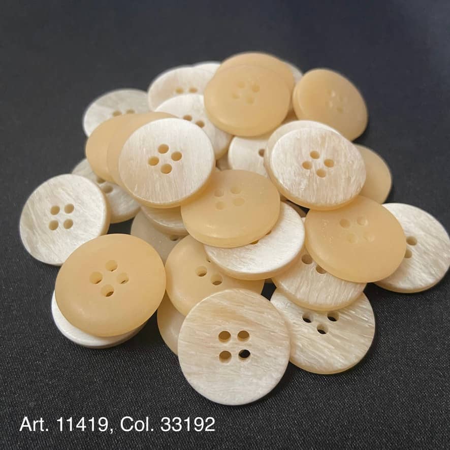 Collection of premium resin buttons for crafts in a light beige color, featuring two holes each