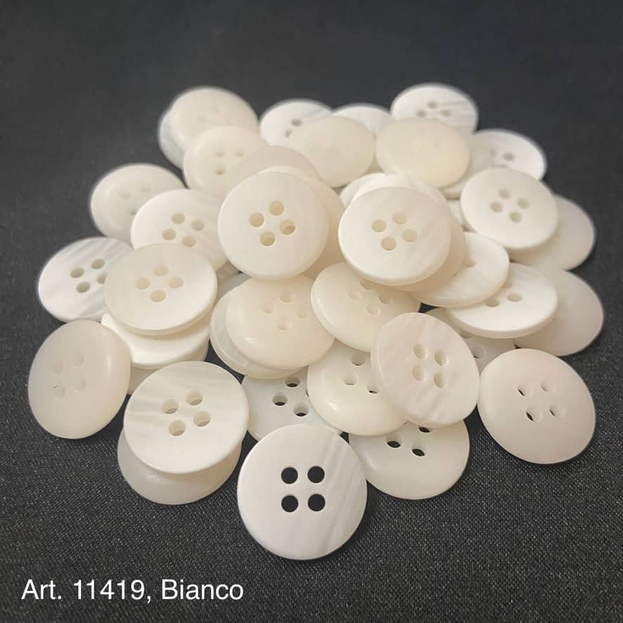 A collection of premium resin buttons for crafts featuring a smooth white finish and four holes