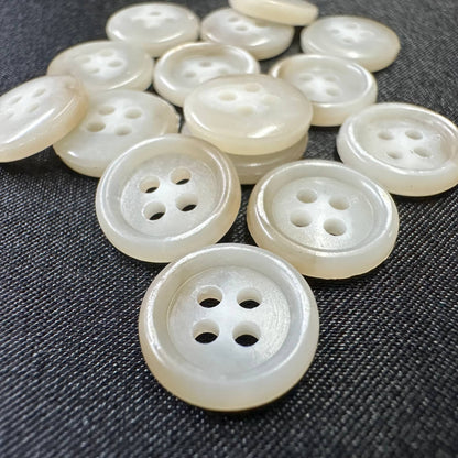 Collection of premium sewing buttons for clothes in a shiny finish, featuring different hole configurations