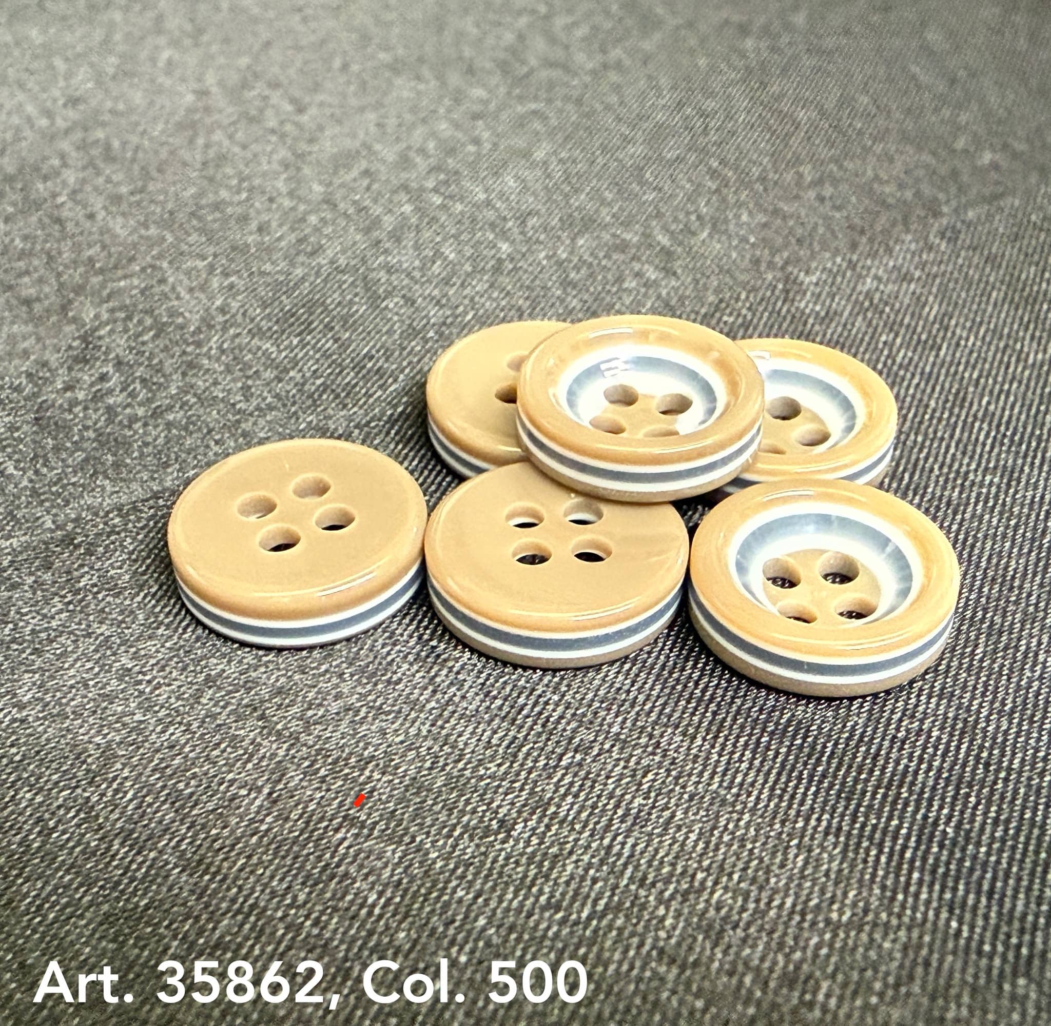 Premium sewing buttons for coats by Buttonology Inc in beige and silver with four holes