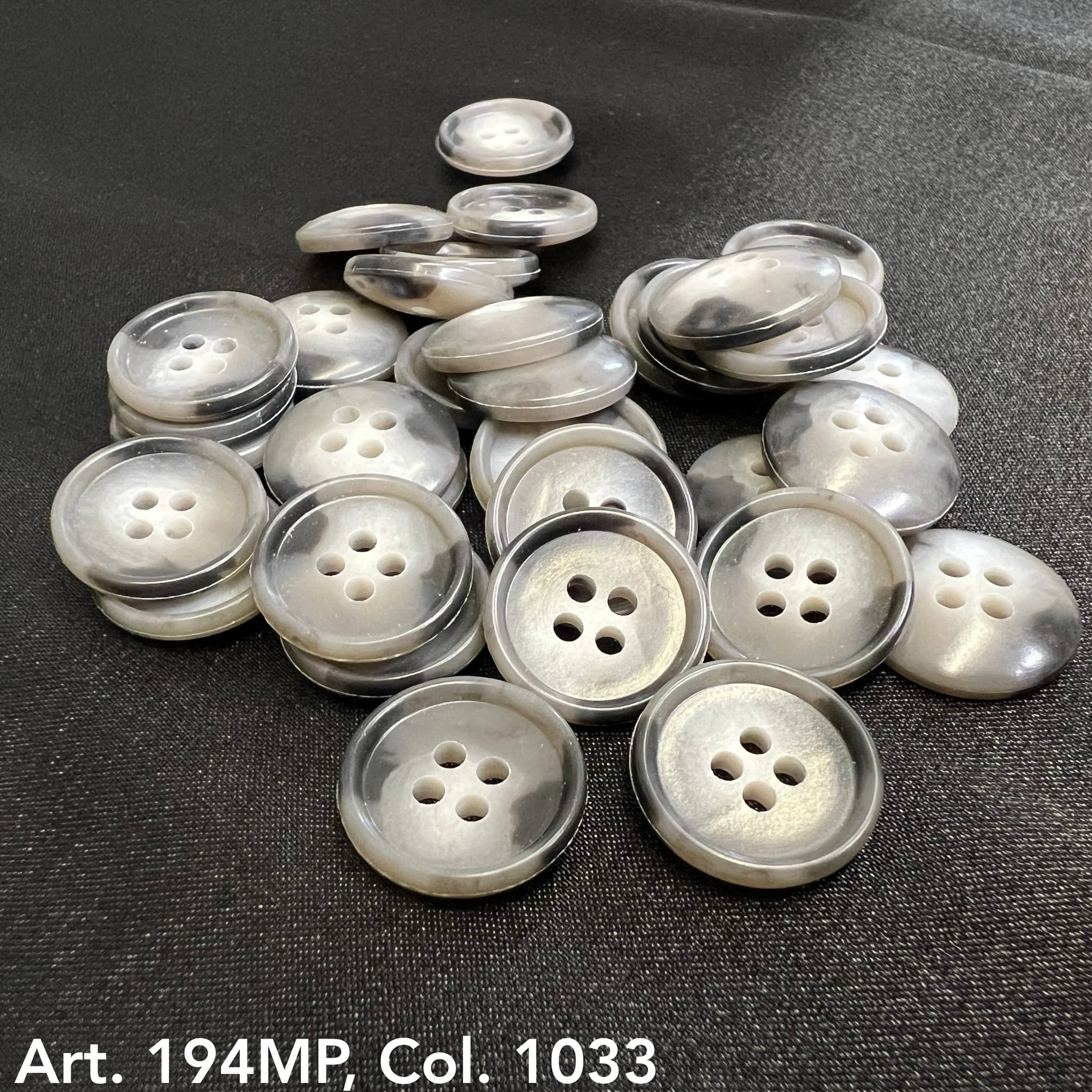 Buttonology Inc premium suit buttons in shiny gray four-hole design on black fabric