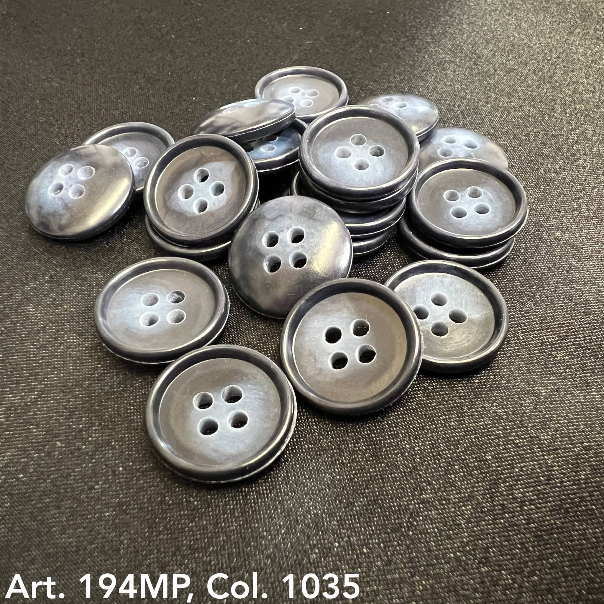 Premium suit buttons by Buttonology Inc in a glossy dark finish, arranged on a black fabric background