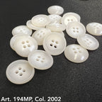 Premium suit buttons by Buttonology Inc in white pearl finish with four holes on black fabric