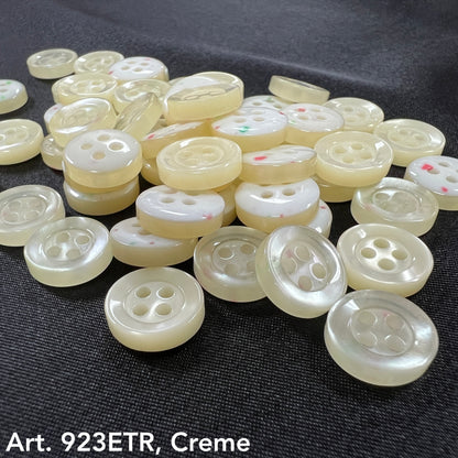 Assorted sew-on buttons for clothing in creamy tones with four holes for easy attachment