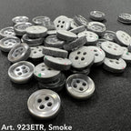 Assorted sew-on buttons for clothing in smoke color, featuring a shiny finish and two holes