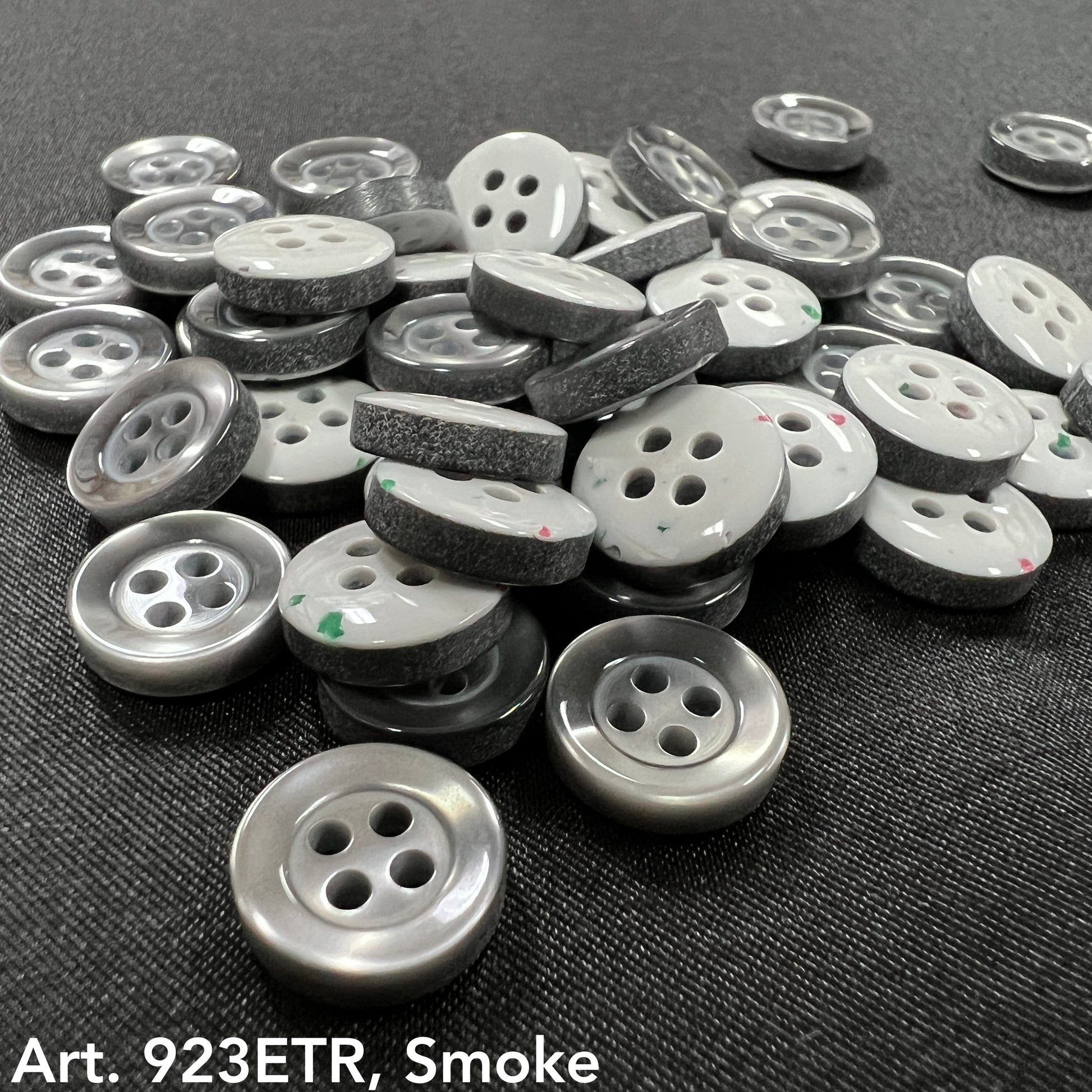 Assorted sew-on buttons for clothing in smoke color, featuring a shiny finish and two holes