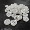 White sewing accessory buttons from Buttonology Inc with four holes on black fabric background