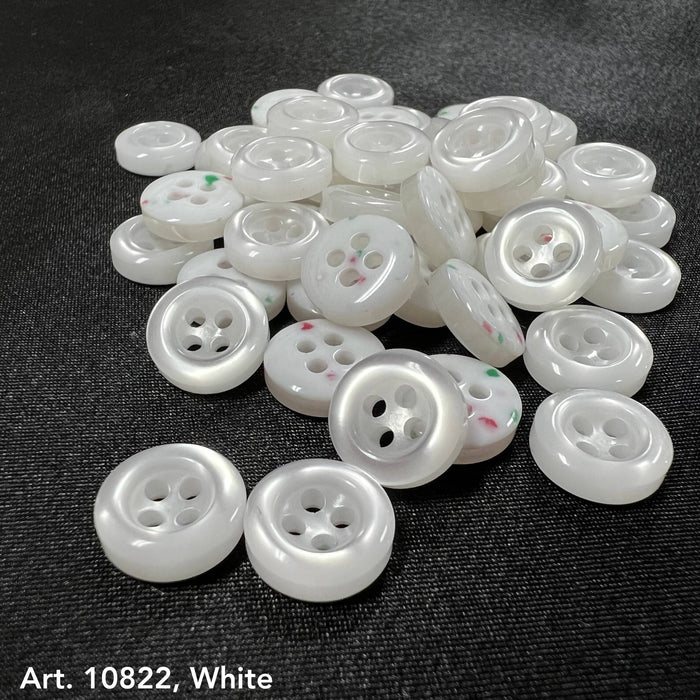 White sewing accessory buttons from Buttonology Inc with four holes on black fabric background