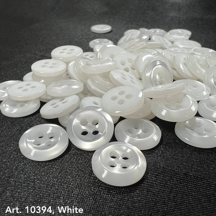 A collection of white sewing buttons for clothing with four holes, ideal for various fabric applications
