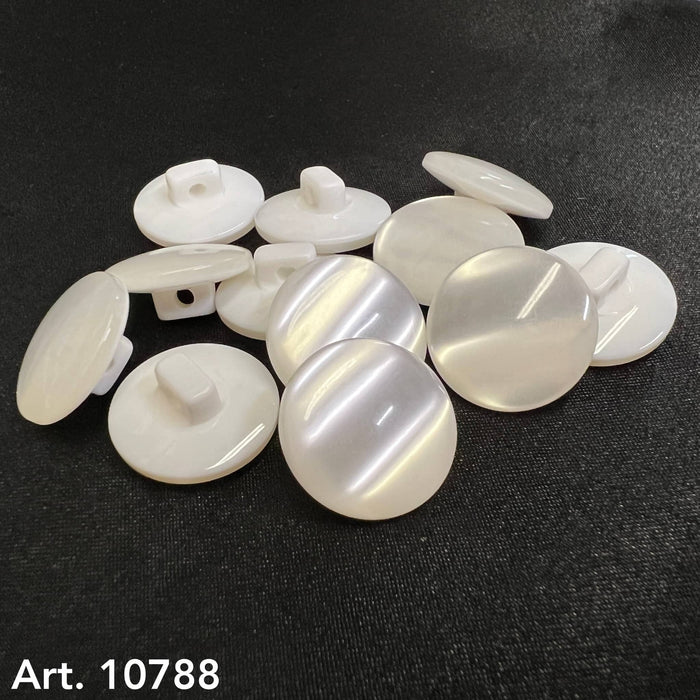 White glossy shank buttons for garments by Buttonology Inc. arranged on black surface