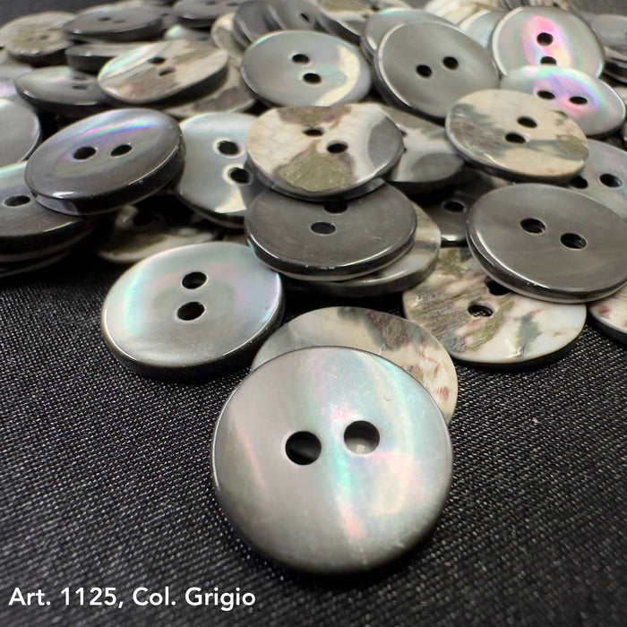Shell buttons for sale by Buttonology Inc featuring round gray iridescent two-hole design on black fabric
