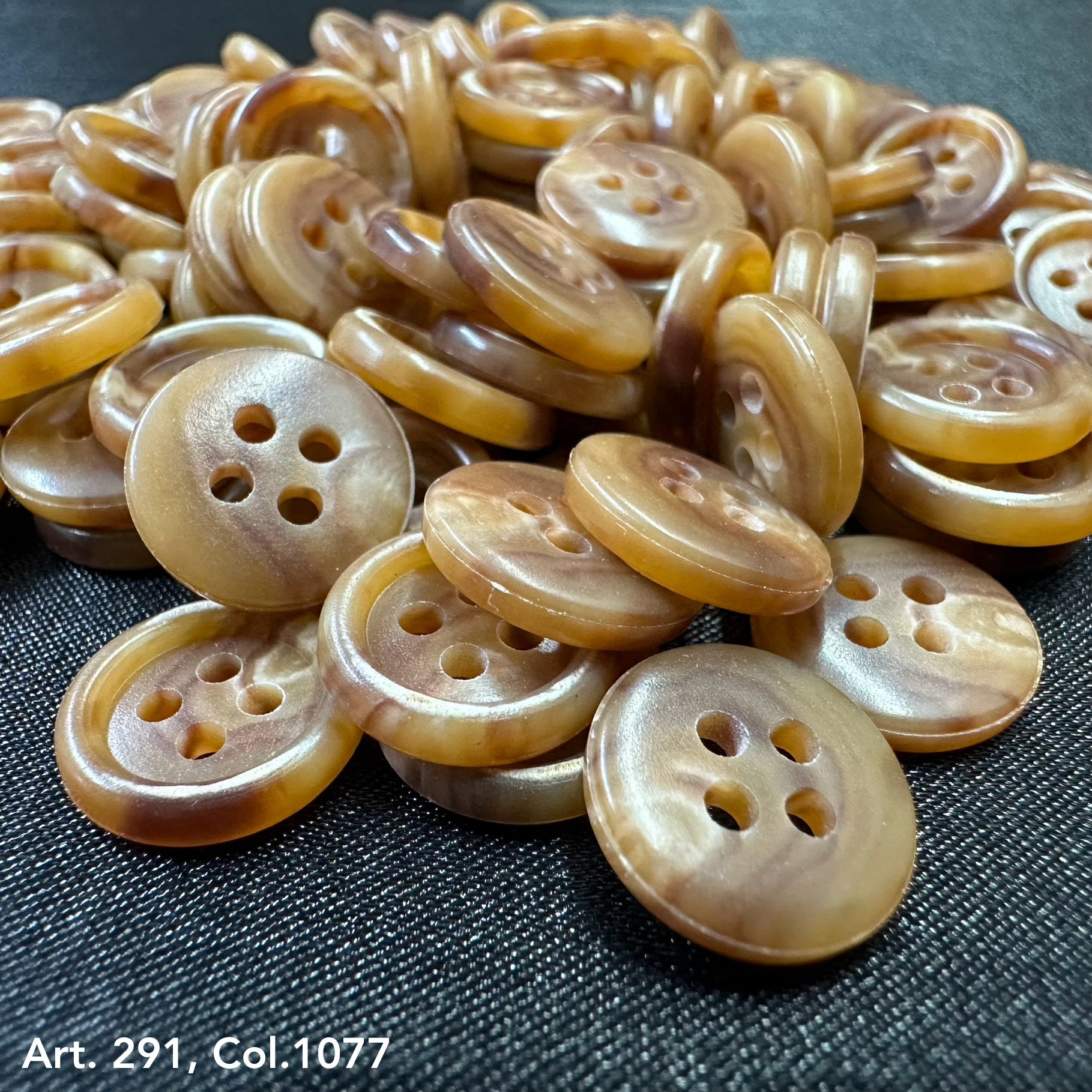 A pile of shirting buttons 18L 20L in warm tones, ideal for clothing and sewing projects