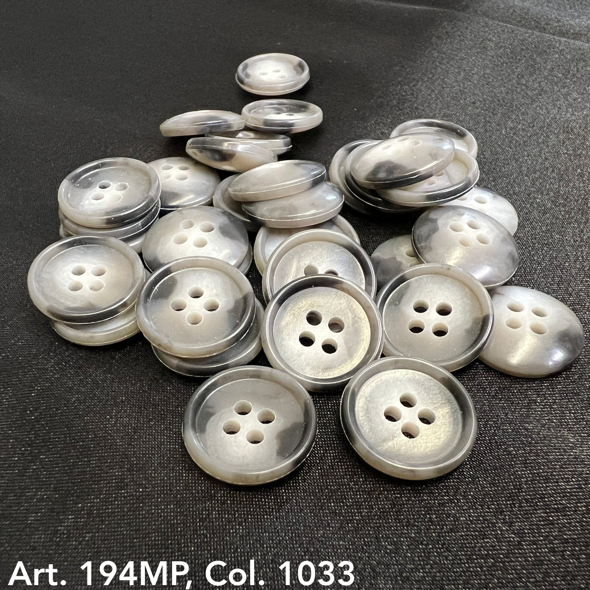 Set of Buttonology Inc. shirting buttons for dress shirts in a mix of colors and styles.