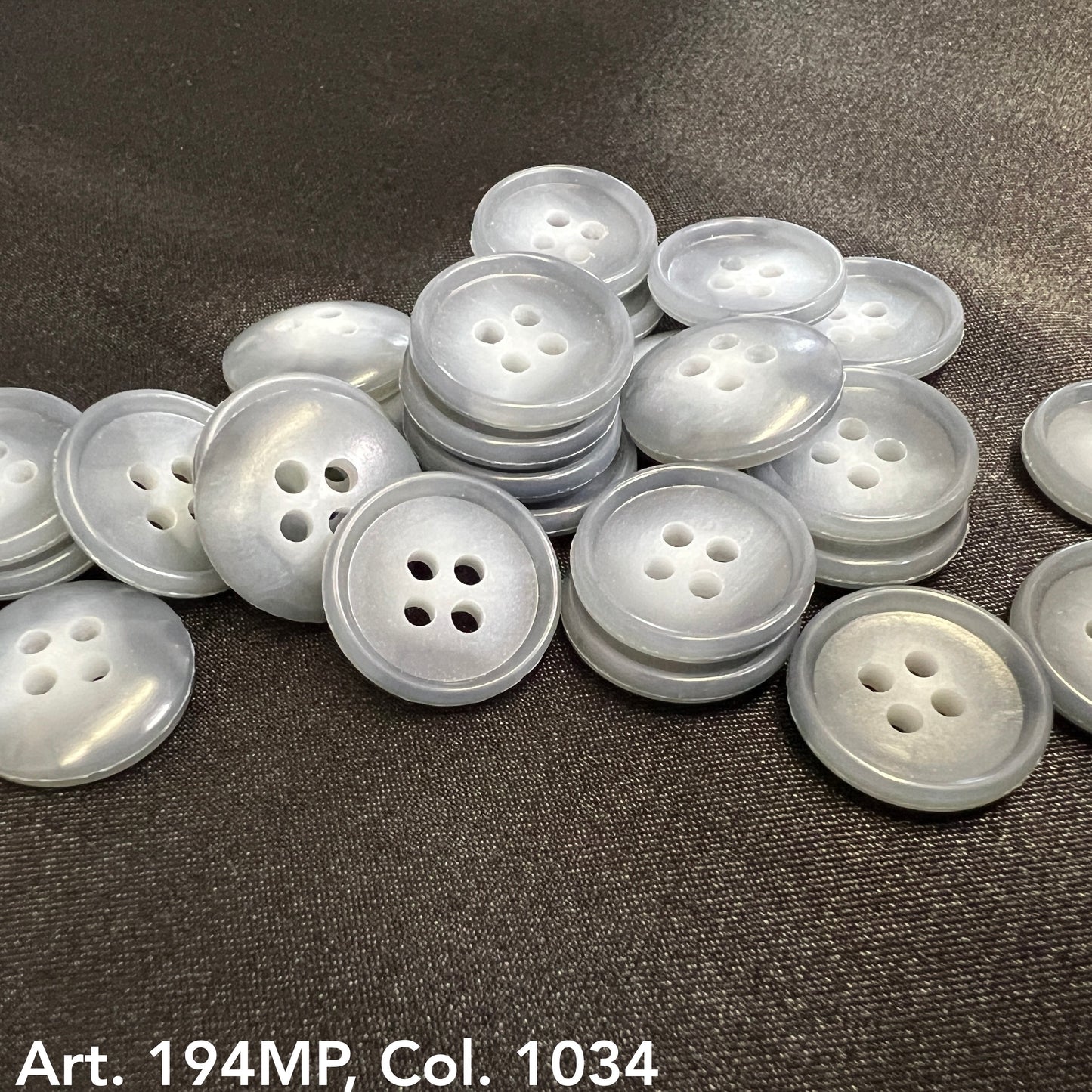High-quality shirting buttons for dress shirts in translucent gray with four holes