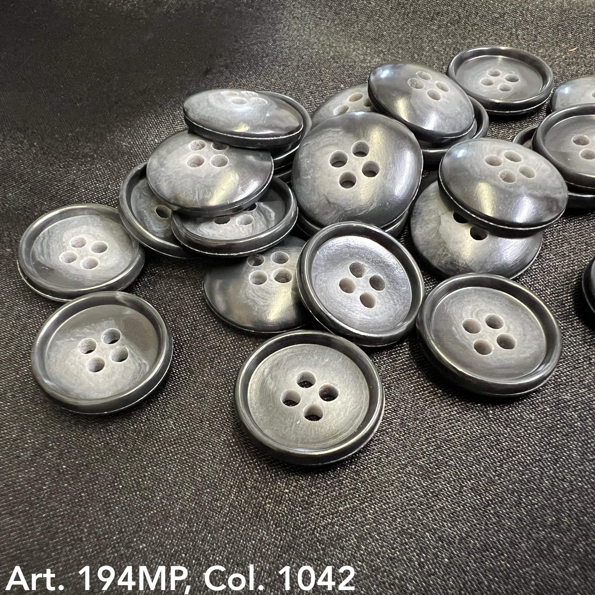 Shirting buttons for dress shirts by Buttonology Inc., featuring a classic dark design and four holes