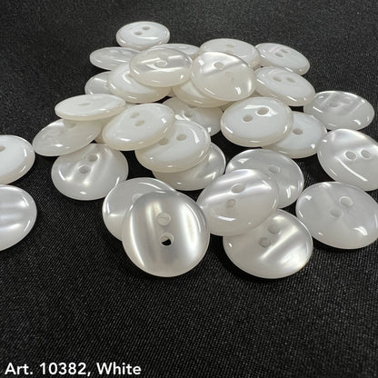 White smoke design buttons for accessories by Buttonology Inc piled on black fabric