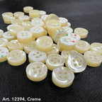 Smoke gray garment buttons by Buttonology Inc in cream color with four holes for sewing on fabric