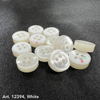 White garment buttons from Buttonology Inc on smoke gray garment buttons background