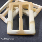 Buttonology Inc beige and white strong polyester buckles with rectangular shape on black background