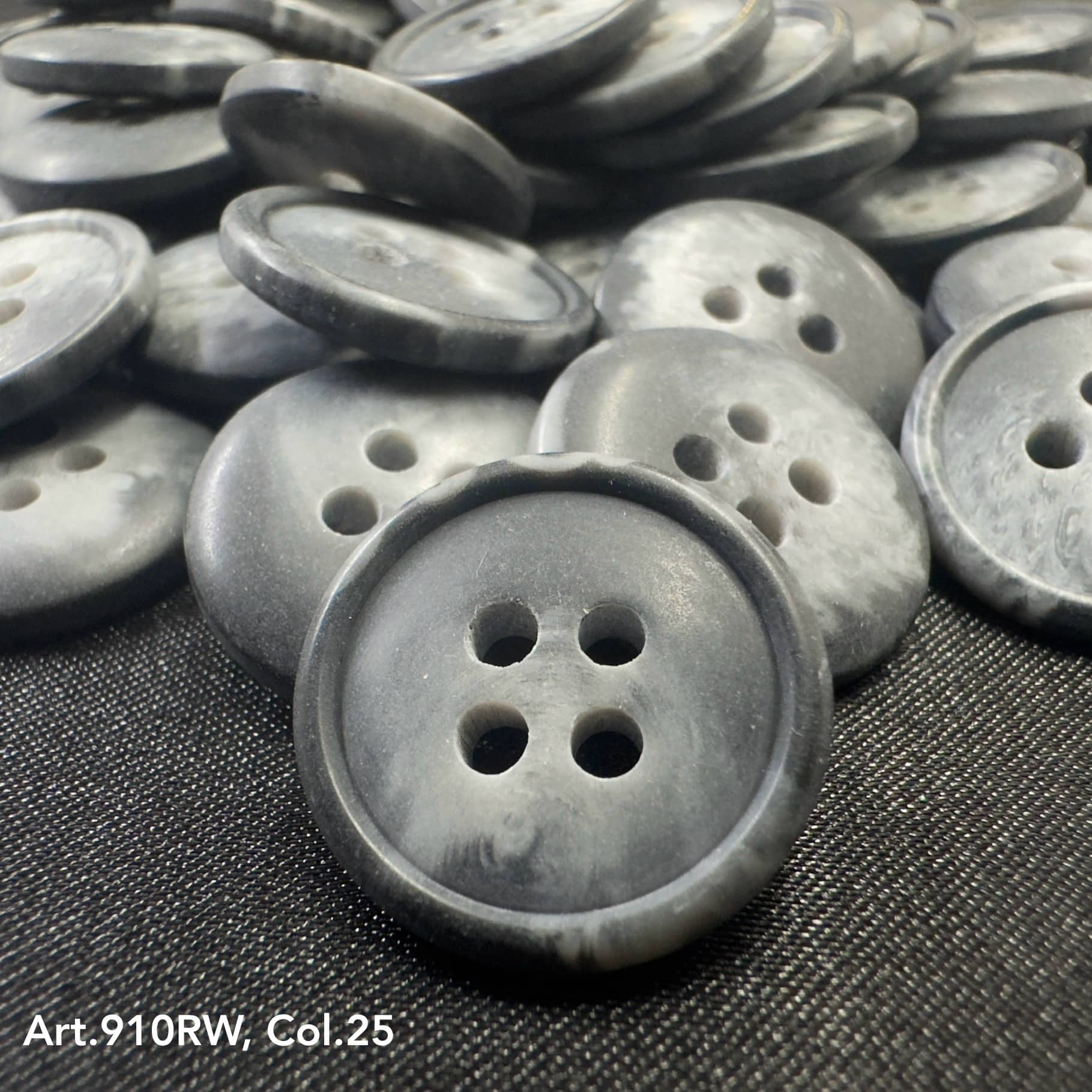 Assorted gray suiting buttons for garments with four holes for sewing and crafting projects