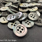 Troca shell buttons in shades of gray with four holes, offered by Buttonology Inc
