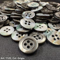 Close-up of Troca shell buttons by Buttonology Inc with a gray and iridescent finish, perfect for sewing projects