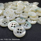 Troca shell buttons by Buttonology Inc with pearly white finish and four holes on black fabric background