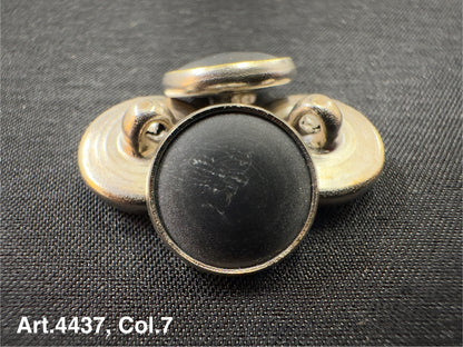 Buttonology Inc black Urea shank buttons with a smooth finish arranged on black fabric