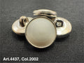 Buttonology Inc urea shank buttons in silver with round smooth surface on black fabric background