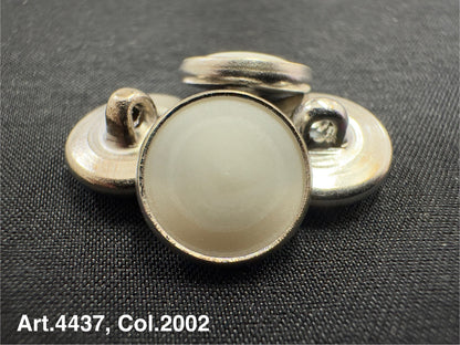 Buttonology Inc urea shank buttons in silver with round smooth surface on black fabric background