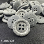 Eco-friendly velvet buttons by Buttonology Inc in gray with a four-hole design on black fabric