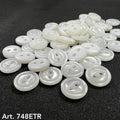 Collection of white pearl garment buttons in various sizes and styles for sewing projects