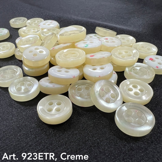 Close-up of cream color buttons with four holes on black fabric wholesale button supplier