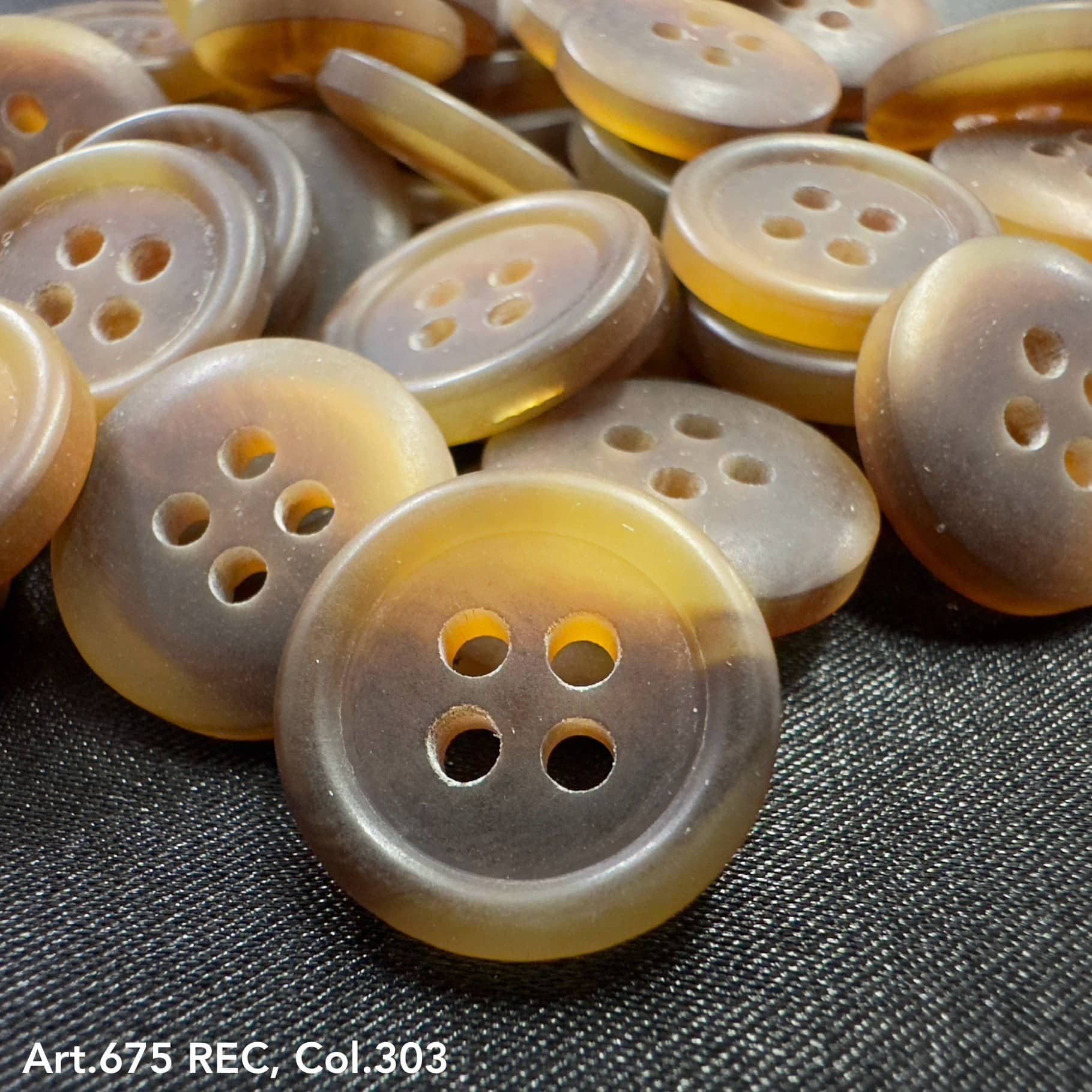 Wholesale four-hole buttons by Buttonology Inc in translucent brown tones on black fabric